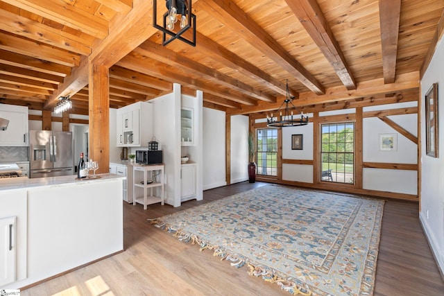 868 Old Hundred Rd, Pelzer, SC 29669 - kitchen featuring stainless steel fridge, black microwave, a chandelier, white cabinetry, and wood ceiling with exposed beams