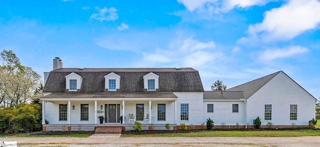 868 Old Hundred Rd, Pelzer, SC 29669 - dutch colonial featuring covered porch, a chimney, a front lawn, and roof with shingles
