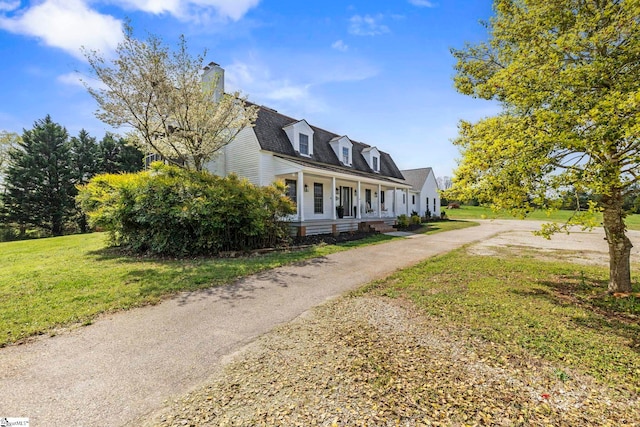 868 Old Hundred Rd, Pelzer, SC 29669 - view of front facade with a porch, a front lawn, and a chimney