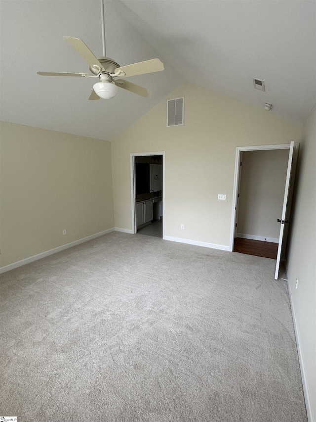 unfurnished room with carpet flooring, ceiling fan, baseboards, and vaulted ceiling
