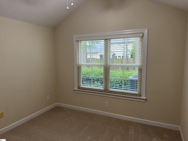 unfurnished room with lofted ceiling, carpet flooring, baseboards, and a ceiling fan