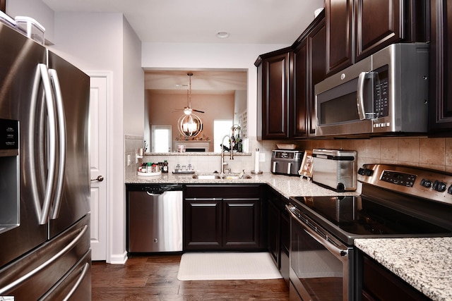 41 Irvington Dr, Greer, SC 29650 - kitchen featuring appliances with stainless steel finishes, a sink, dark brown cabinets, light stone counters, and dark wood finished floors