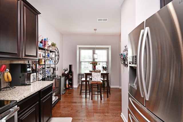 41 Irvington Dr, Greer, SC 29650 - kitchen with stainless steel fridge, dark brown cabinets, wood finished floors, and light stone counters