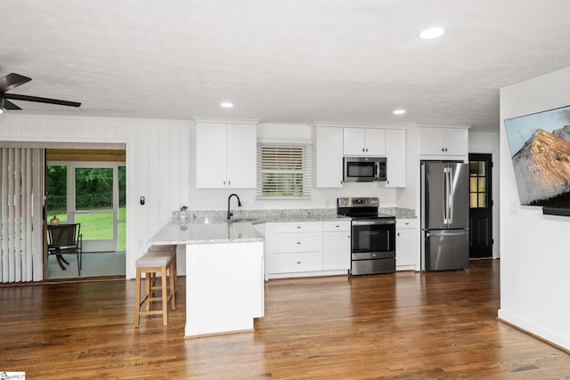 502 Hunts Bridge Rd, Greenville, SC 29617 - kitchen with stainless steel appliances, plenty of natural light, white cabinetry, light stone counters, and recessed lighting