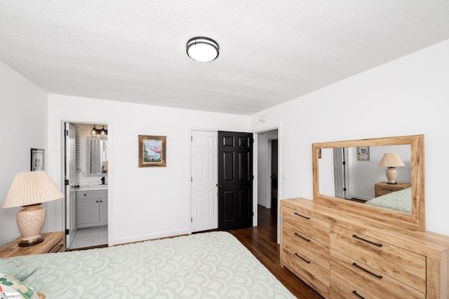 502 Hunts Bridge Rd, Greenville, SC 29617 - bedroom with dark wood-style flooring, ensuite bath, a sink, a closet, and baseboards