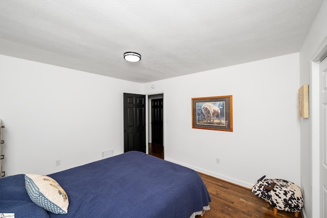 502 Hunts Bridge Rd, Greenville, SC 29617 - bedroom featuring wood finished floors, baseboards, and a textured ceiling