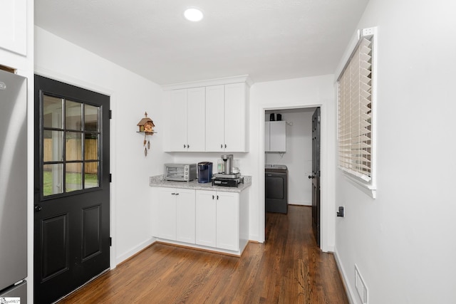 502 Hunts Bridge Rd, Greenville, SC 29617 - kitchen with washer / clothes dryer, freestanding refrigerator, white cabinets, dark wood-type flooring, and baseboards