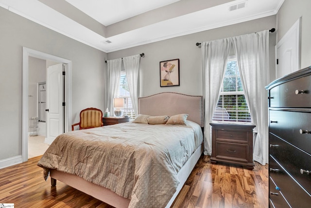 104 Penrith Ct, Simpsonville, SC 29681 - bedroom with wood finished floors, ornamental molding, baseboards, ensuite bathroom, and a tray ceiling