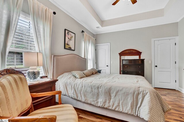 104 Penrith Ct, Simpsonville, SC 29681 - bedroom with a tray ceiling, wood finished floors, crown molding, and ceiling fan