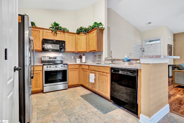 104 Penrith Ct, Simpsonville, SC 29681 - kitchen with black appliances, a peninsula, tasteful backsplash, a sink, and light stone countertops