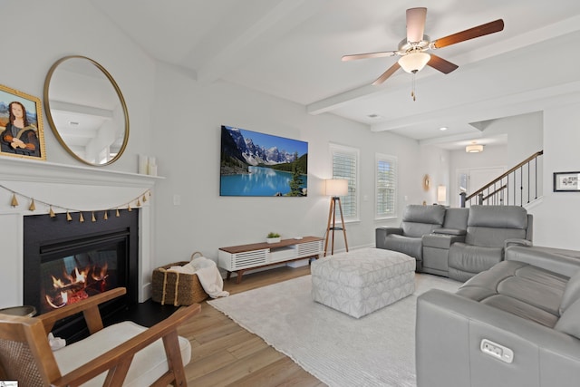 603 Betony Way, Greenville, SC 29607 - living room featuring light wood-type flooring, beam ceiling, a glass covered fireplace, a ceiling fan, and stairs