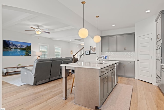 603 Betony Way, Greenville, SC 29607 - kitchen with gray cabinetry, open floor plan, a sink, light wood-type flooring, and beam ceiling