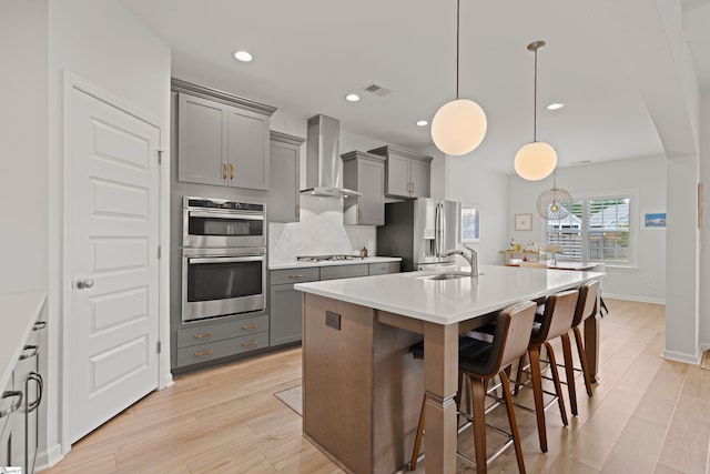 603 Betony Way, Greenville, SC 29607 - kitchen featuring wall chimney exhaust hood, gray cabinets, stainless steel appliances, light wood-style floors, and recessed lighting