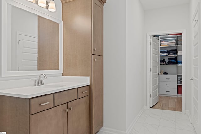 603 Betony Way, Greenville, SC 29607 - bathroom featuring vanity, marble look tiles, baseboards, and a spacious closet