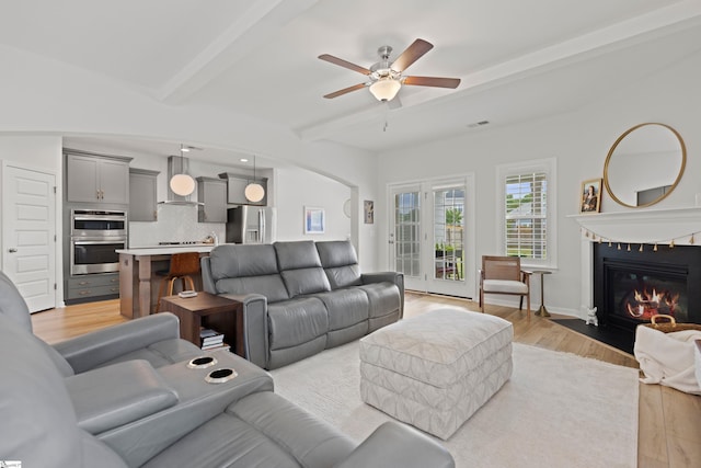 603 Betony Way, Greenville, SC 29607 - living room featuring beamed ceiling, a ceiling fan, a fireplace with flush hearth, light wood-style flooring, and arched walkways