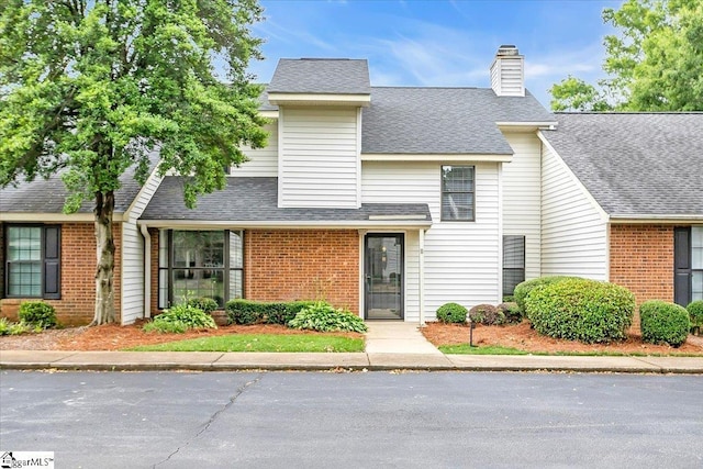 11 Forest Lake Dr, Simpsonville, SC 29681 - view of front of property featuring brick siding, a chimney, and roof with shingles