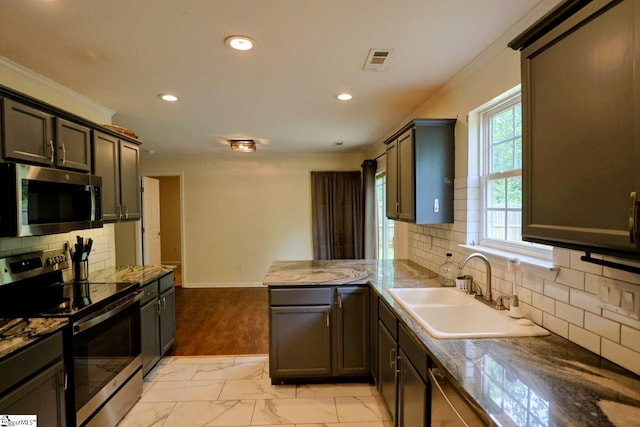 208 Catterick Way, Fountain Inn, SC 29644 - kitchen with appliances with stainless steel finishes, a sink, a peninsula, recessed lighting, and tasteful backsplash