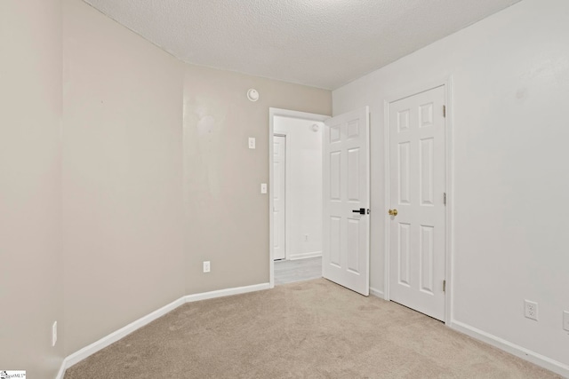 147 Highland Ridge Trl, Boiling Springs, SC 29316 - unfurnished bedroom featuring light colored carpet, baseboards, and a textured ceiling