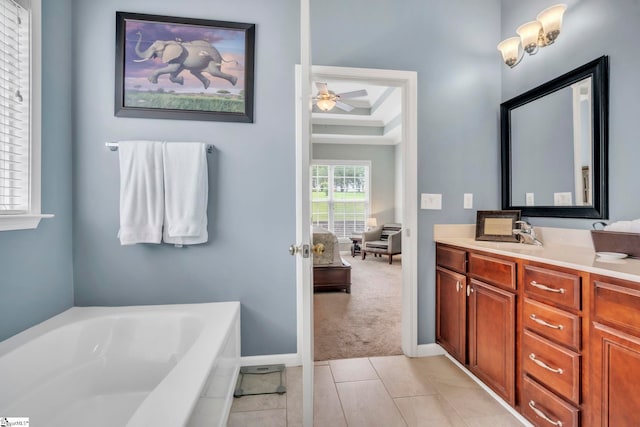 721 Dutchman Ct, Greer, SC 29651 - bathroom with vanity, a garden tub, ceiling fan, tile patterned flooring, and a tray ceiling