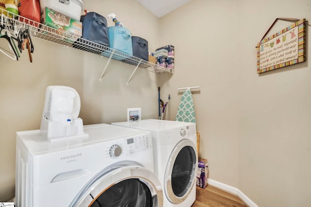 721 Dutchman Ct, Greer, SC 29651 - laundry area featuring washing machine and clothes dryer, wood finished floors, and baseboards