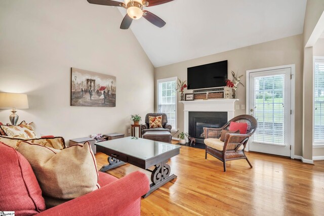 721 Dutchman Ct, Greer, SC 29651 - living room featuring a fireplace with flush hearth, ceiling fan, light wood-style floors, and high vaulted ceiling