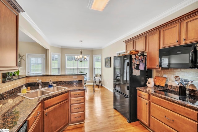 721 Dutchman Ct, Greer, SC 29651 - kitchen featuring black appliances, a sink, a chandelier, backsplash, and ornamental molding