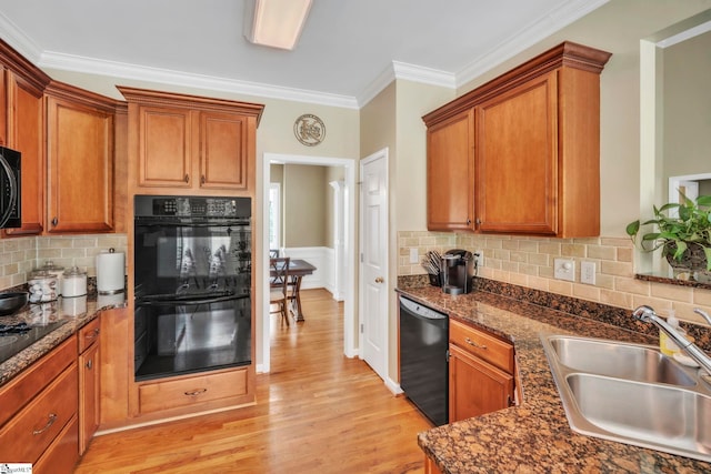 721 Dutchman Ct, Greer, SC 29651 - kitchen with black appliances, a sink, crown molding, light wood-style flooring, and brown cabinets