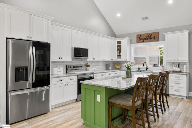 100 Grandview Dr, Anderson, SC 29625 - kitchen with stainless steel appliances, tasteful backsplash, white cabinets, a breakfast bar area, and recessed lighting