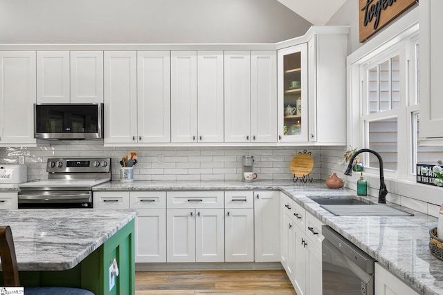100 Grandview Dr, Anderson, SC 29625 - kitchen featuring stainless steel appliances, a sink, white cabinetry, backsplash, and vaulted ceiling