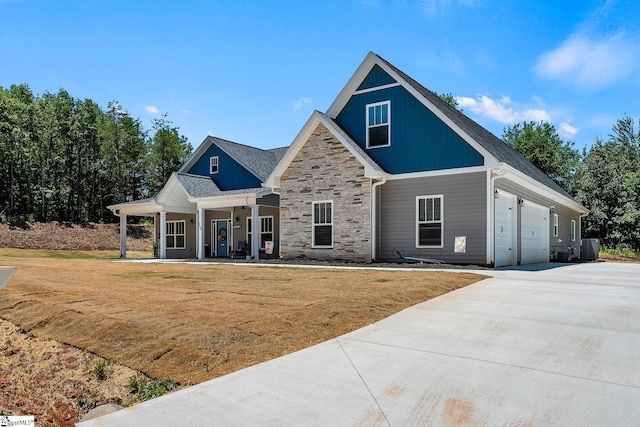 100 Grandview Dr, Anderson, SC 29625 - craftsman-style home featuring stone siding, a front lawn, a porch, driveway, and a garage