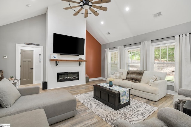 100 Grandview Dr, Anderson, SC 29625 - living area with high vaulted ceiling, a ceiling fan, baseboards, a glass covered fireplace, and light wood-type flooring
