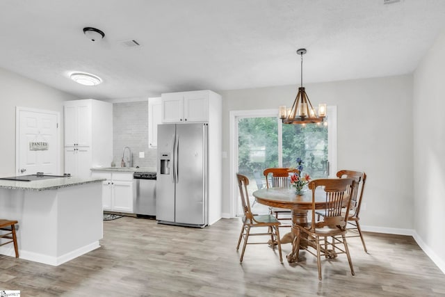 113 Sedgefield Ct, Anderson, SC 29621 - kitchen featuring stainless steel appliances, light wood finished floors, white cabinets, and light stone countertops