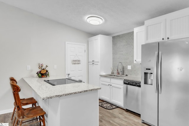 113 Sedgefield Ct, Anderson, SC 29621 - kitchen featuring stainless steel appliances, a sink, a peninsula, a kitchen breakfast bar, and white cabinets