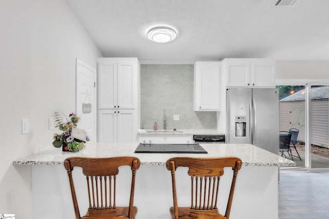 113 Sedgefield Ct, Anderson, SC 29621 - kitchen featuring stainless steel fridge, a sink, a kitchen bar, and white cabinetry