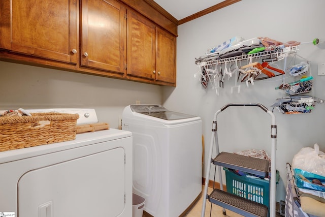 304 Oak Brook Way, Taylors, SC 29687 - laundry area featuring cabinet space, independent washer and dryer, ornamental molding, and light tile patterned floors