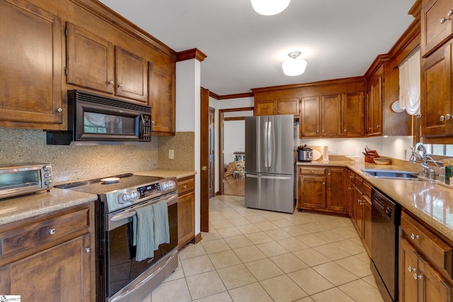 304 Oak Brook Way, Taylors, SC 29687 - kitchen featuring black appliances, a sink, decorative backsplash, light tile patterned floors, and brown cabinets