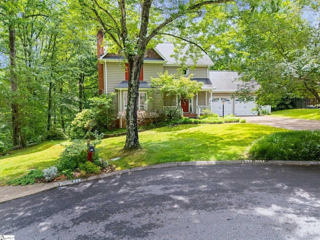 304 Oak Brook Way, Taylors, SC 29687 - view of front of property featuring an attached garage, asphalt driveway, a front yard, a chimney, and a porch