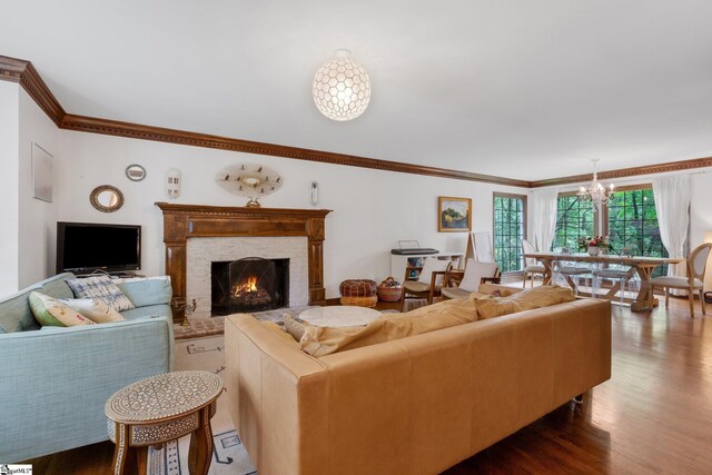 304 Oak Brook Way, Taylors, SC 29687 - living room featuring a chandelier, ornamental molding, dark wood-style flooring, and a brick fireplace