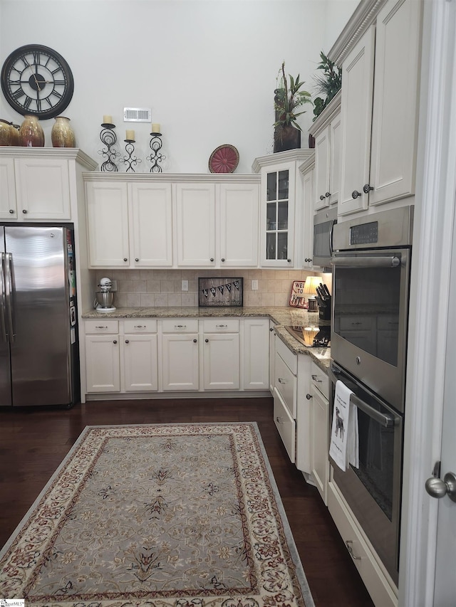 256 Chickadee Trl, Easley, SC 29642 - kitchen featuring appliances with stainless steel finishes, decorative backsplash, white cabinetry, and glass insert cabinets