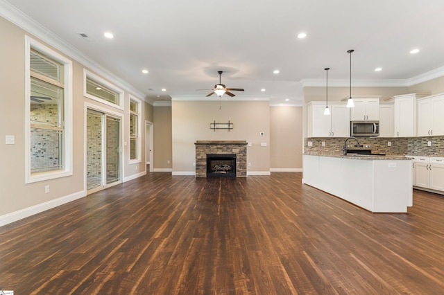 121 Floyd Meadow Dr, Inman, SC 29349 - kitchen featuring stainless steel microwave, open floor plan, dark wood finished floors, ceiling fan, and light stone counters