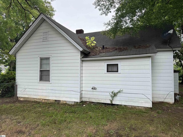 12 Stevens St, Laurens, SC 29360 - view of home's exterior with a shingled roof and a chimney
