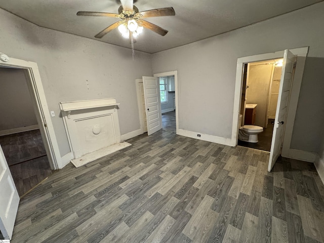 12 Stevens St, Laurens, SC 29360 - unfurnished bedroom featuring wood finished floors, baseboards, ensuite bath, and a ceiling fan