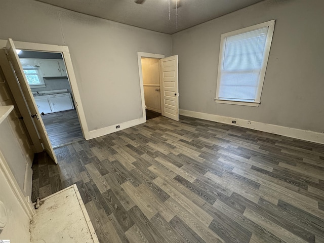 12 Stevens St, Laurens, SC 29360 - unfurnished bedroom with dark wood finished floors and baseboards