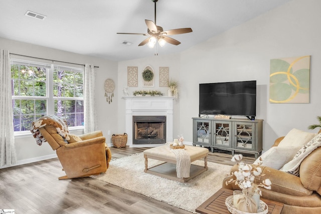137 Mediterranean Ave, Anderson, SC 29621 - living room featuring wood finished floors, a fireplace, ceiling fan, vaulted ceiling, and baseboards