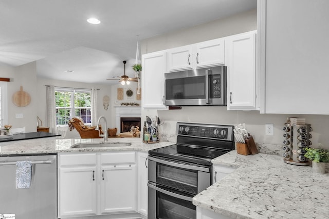 137 Mediterranean Ave, Anderson, SC 29621 - kitchen featuring stainless steel appliances, a sink, a peninsula, white cabinetry, and ceiling fan