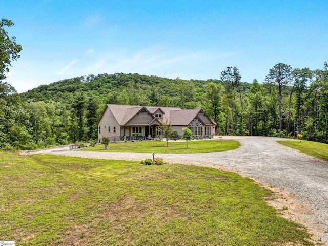 1061 Hidden Glory Dr, Landrum, SC 29356 - view of front of property featuring a forest view, a front yard, and curved driveway