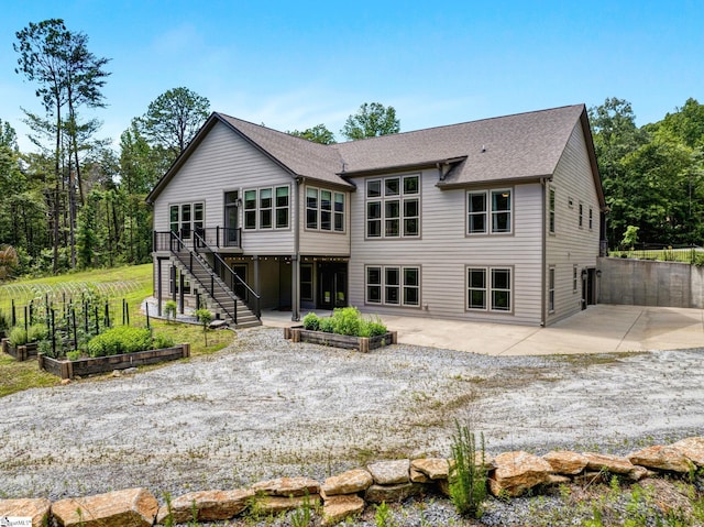 1061 Hidden Glory Dr, Landrum, SC 29356 - back of house with a vegetable garden, a patio, stairway, a deck, and a shingled roof