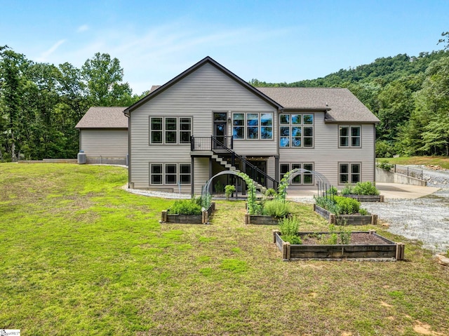 1061 Hidden Glory Dr, Landrum, SC 29356 - rear view of house featuring a garden, a yard, stairs, and a deck
