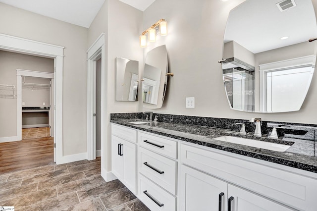 1061 Hidden Glory Dr, Landrum, SC 29356 - full bath featuring double vanity, a shower stall, a walk in closet, and baseboards