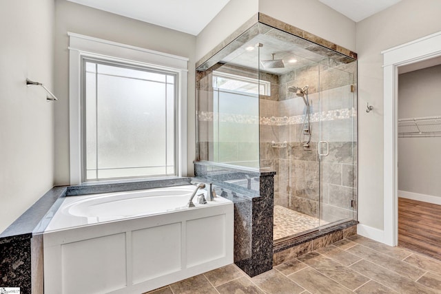 1061 Hidden Glory Dr, Landrum, SC 29356 - full bath with a shower stall, a bath, a walk in closet, and baseboards
